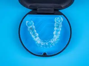 A patients Invisalign trays in their case in Garland, TX